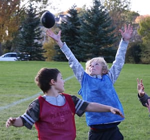 A flag football player goes for a circus catch!